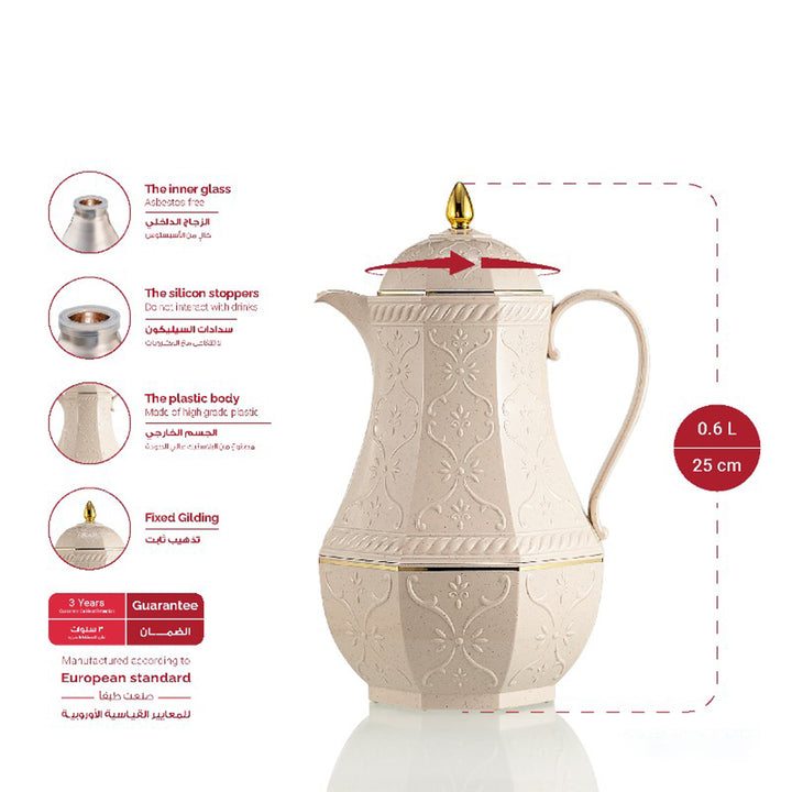 Decorative white teapot with gold accents on a white background