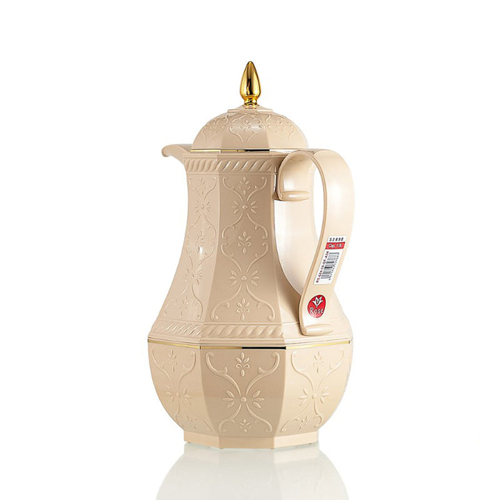 Beige ceramic teapot with gold accents on a white background
