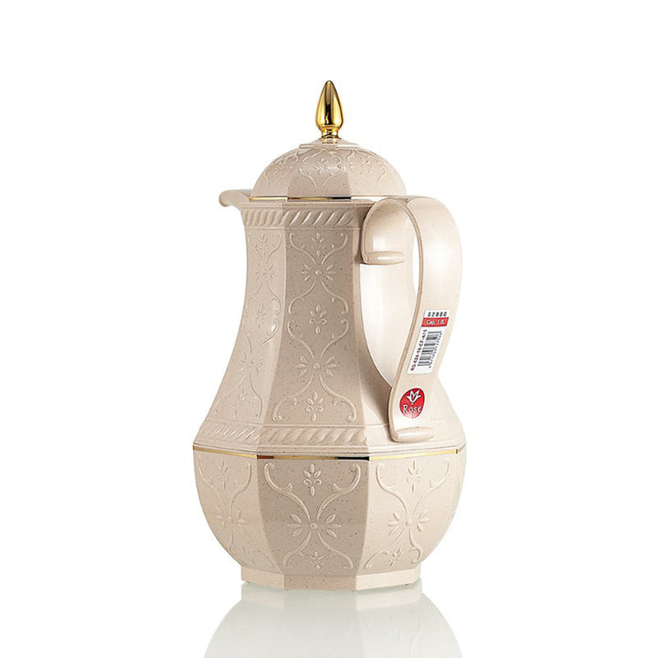 Decorative cream-colored teapot with gold accents on a white background