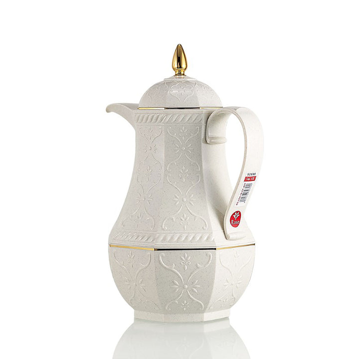 White ceramic coffee pot with gold accents on a white background