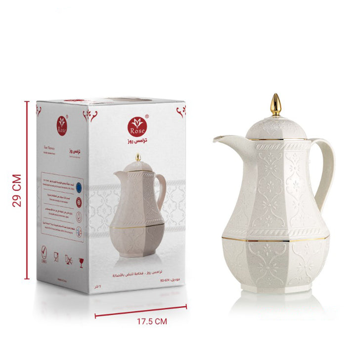 White ceramic teapot with gold accents next to its packaging box on a white background