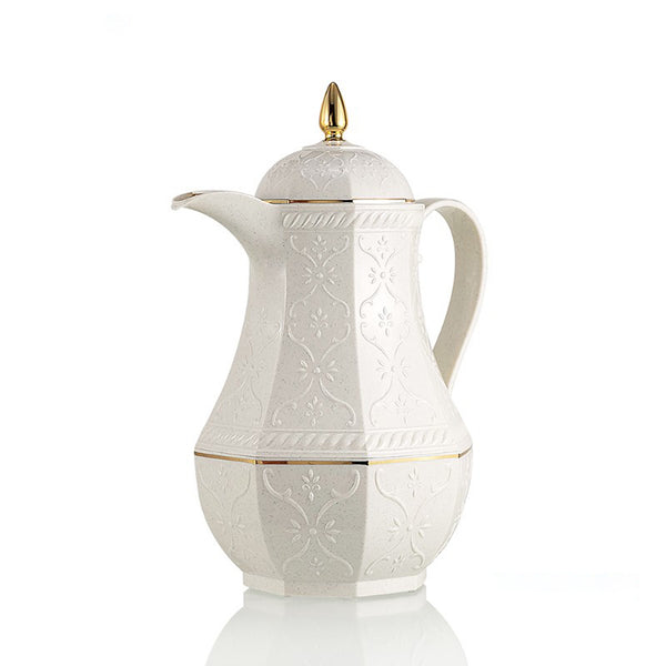 White ceramic coffee pot with gold accents on a white background