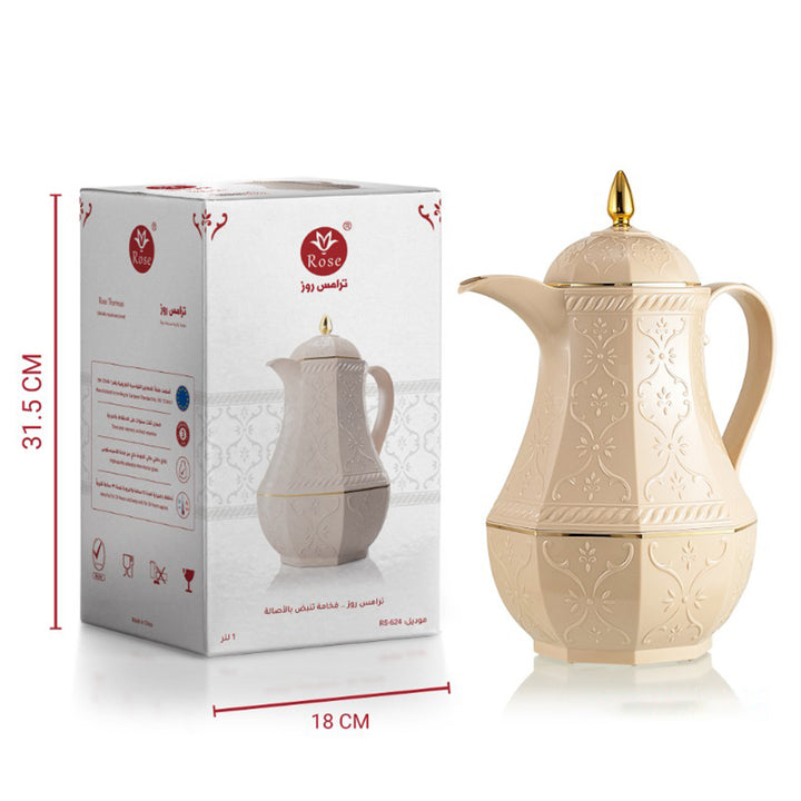 Beige ceramic coffee pot with gold accents next to its packaging box on a white background