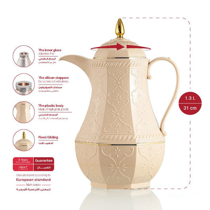 Decorative cream-colored teapot with gold accents on a white background