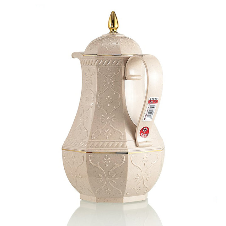 Decorative cream-colored teapot with gold accents on a white background