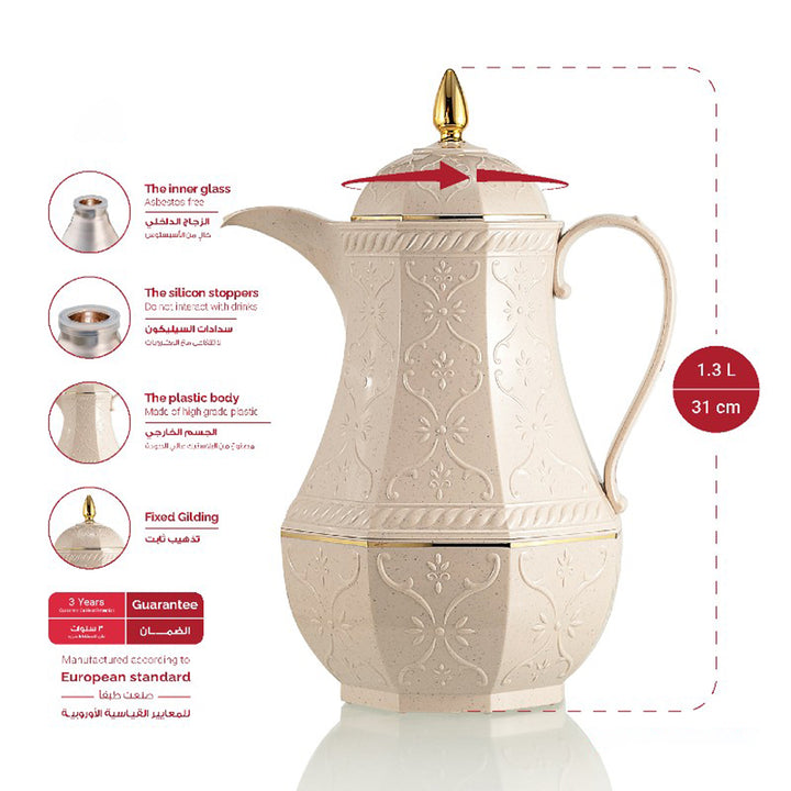 Decorative cream-colored teapot with gold accents on a white background