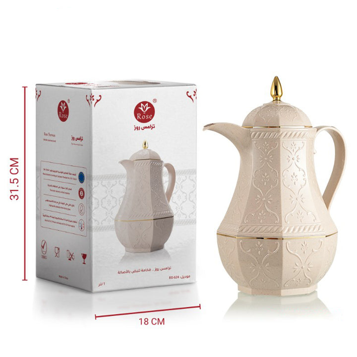 Beige ceramic coffee pot with gold accents next to its packaging box on a white background