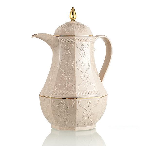 Decorative cream-colored coffee pot with gold accents on a white background