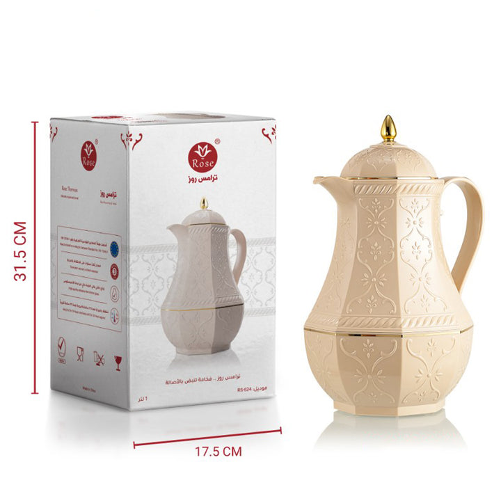 Cream-colored ceramic pitcher with gold accents next to its packaging box on a white background
