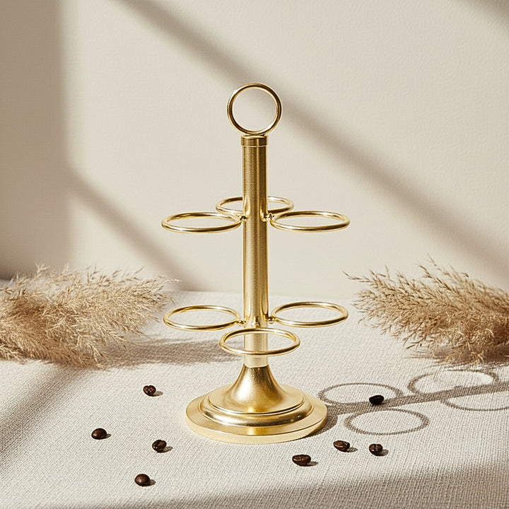 Gold cawa cup holder stand on a neutral background with decorative elements