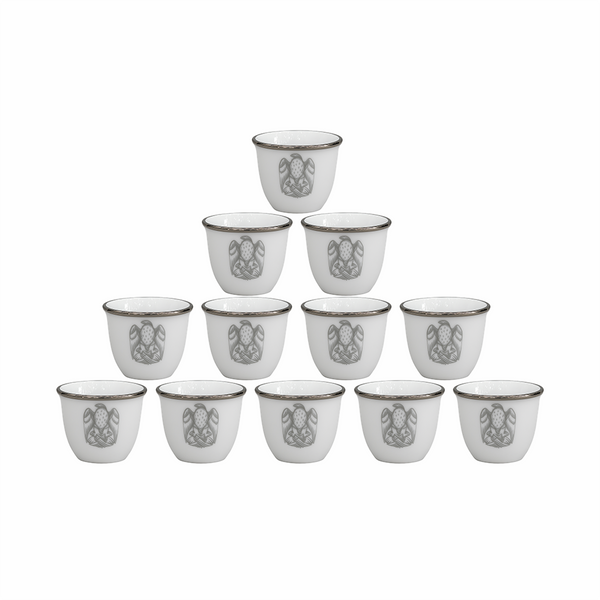 Set of twelve white ceramic cups with decorative patterns on a white background