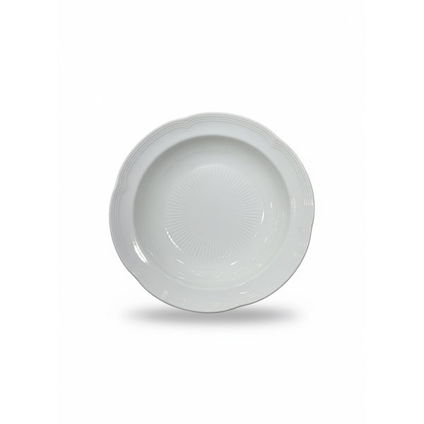 White ceramic bowl with decorative rim on a white background