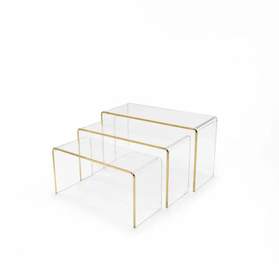Elegant Three Piece Clear Acrylic Cake Holder Set With Refined Gold Line Detailing, Designed For Displaying And Serving Cakes, Cupcakes, Pastries, Desserts, Sweets, And Other Treats At Siddiq Gifts.