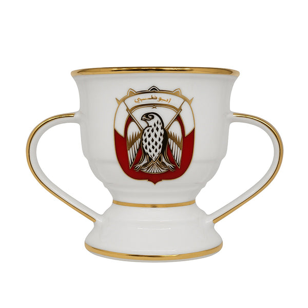 Decorative cup with handles and a central emblem on a white background