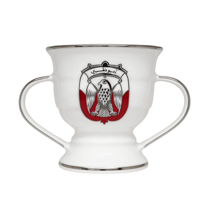 White cup with handles featuring a central emblem on a white background