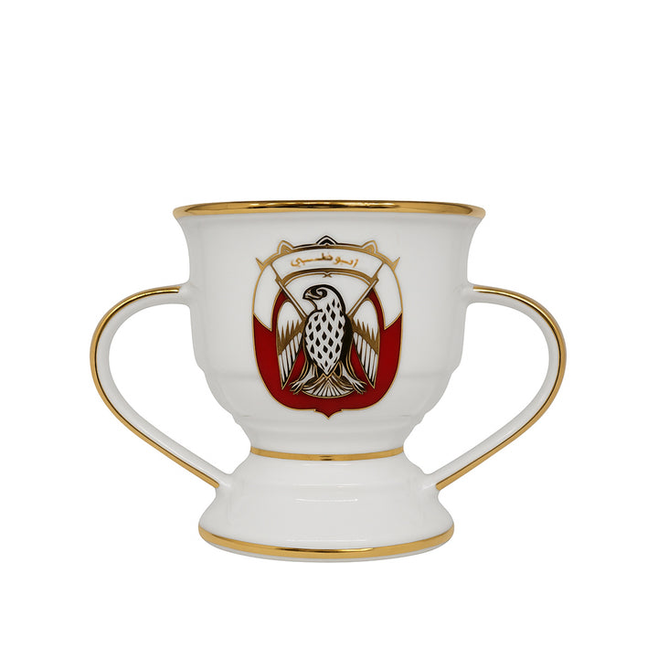 Decorative cup with handles and a central emblem on a white background