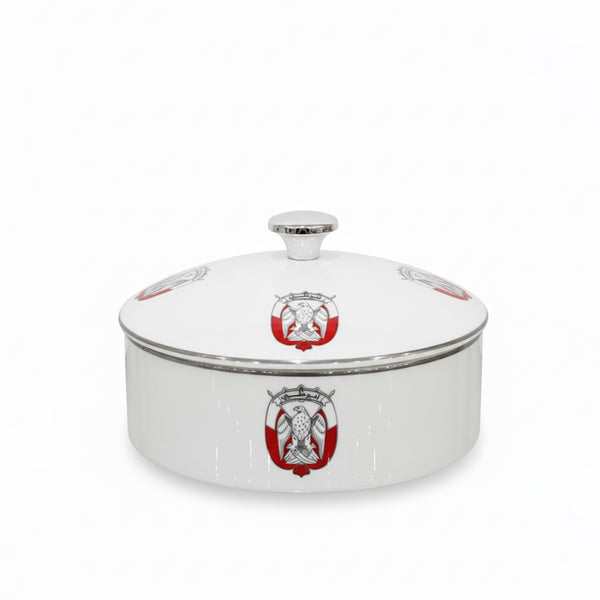 White ceramic dish with red and gold emblem on a white background