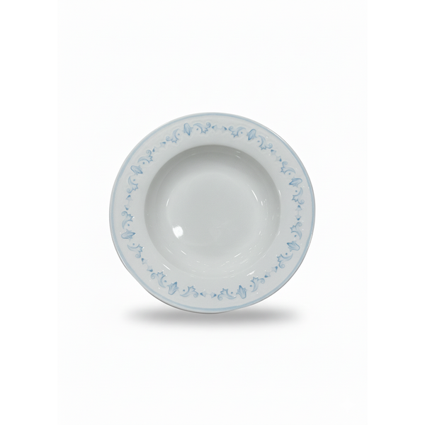 White ceramic bowl with blue floral patterns on a white background