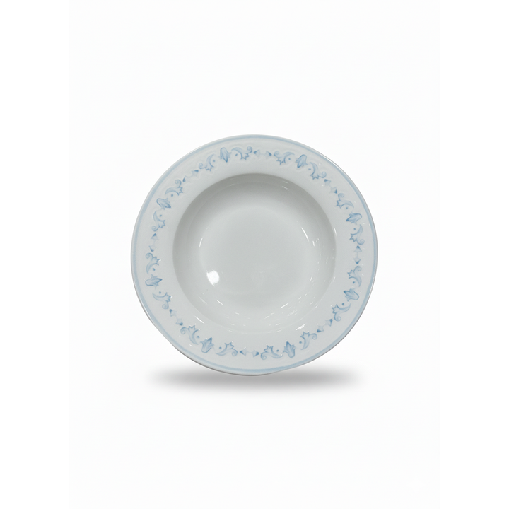 White ceramic bowl with blue floral patterns on a white background