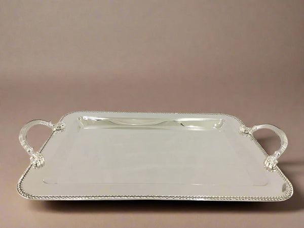 A rectangular silver metal serving tray with handles.