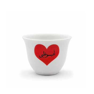 Elegant 12-Piece White Cawa Cup Set With A Red Abu Dhabi Heart Design, Perfect For Serving Arabic Coffee During Gatherings And Special Occasions At Siddiq Gifts.