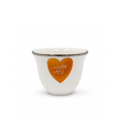 Elegant Twelve Piece White Ceramic Cawa Cup Set Featuring A Bint-E-Zaid Heart Design And Refined Silver Rim, Ideal For Serving Arabic Coffee During Gatherings And Special Occasions At Siddiq Gifts.