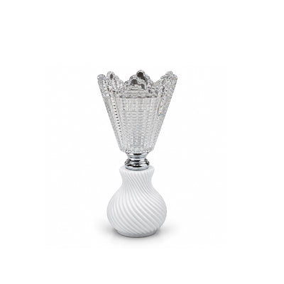 A clear cut-glass goblet with a flared, textured rim and a white ribbed pedestal base, shown on a clean white background.