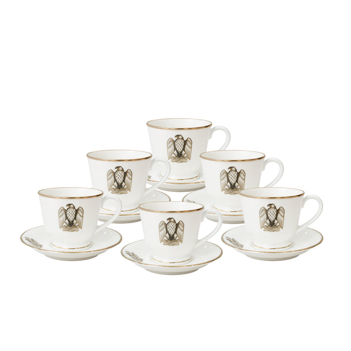 Set of six white cups and saucers with gold accents on a white background