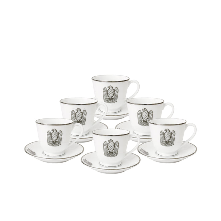 Set of six white espresso cups and saucers with black emblem on a white background