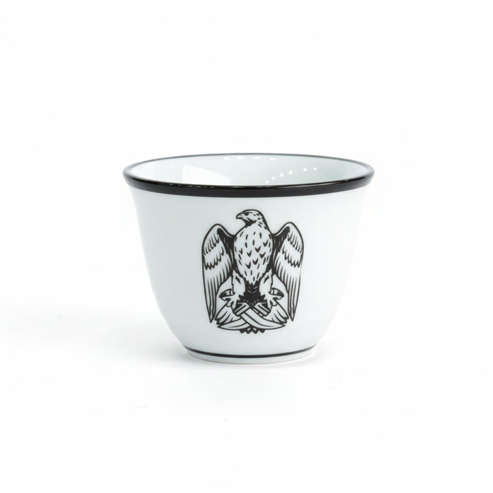 White cup with black rim and eagle design on a white background