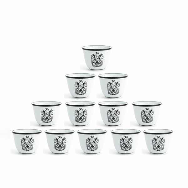 Set of 12 small black and white cups with decorative patterns on a white background