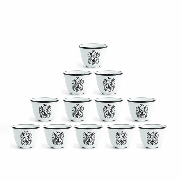 Set of 12 small black and white cups with decorative patterns on a white background