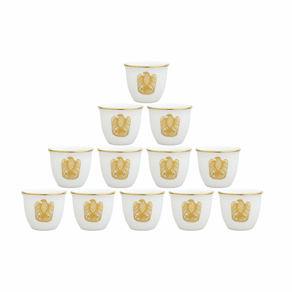 Set of twelve white cups with gold decorative elements on a white background