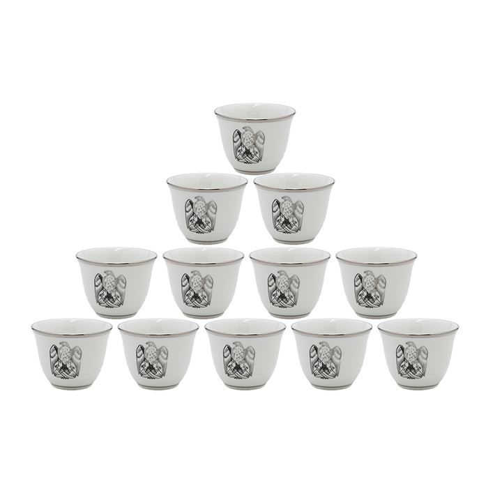 Set of twelve white ceramic cups with black decorative patterns on a white background