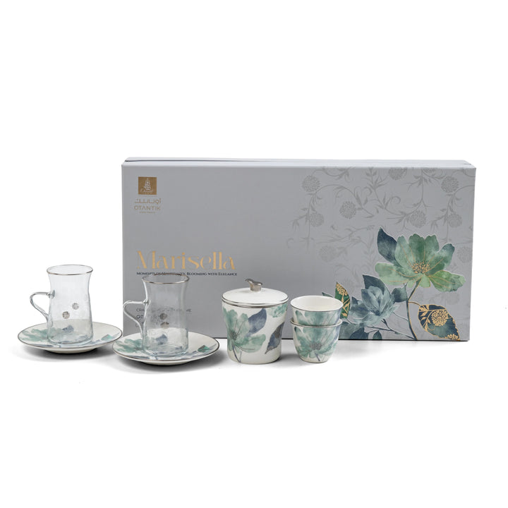 Tea set with floral design in front of a branded box on a white background