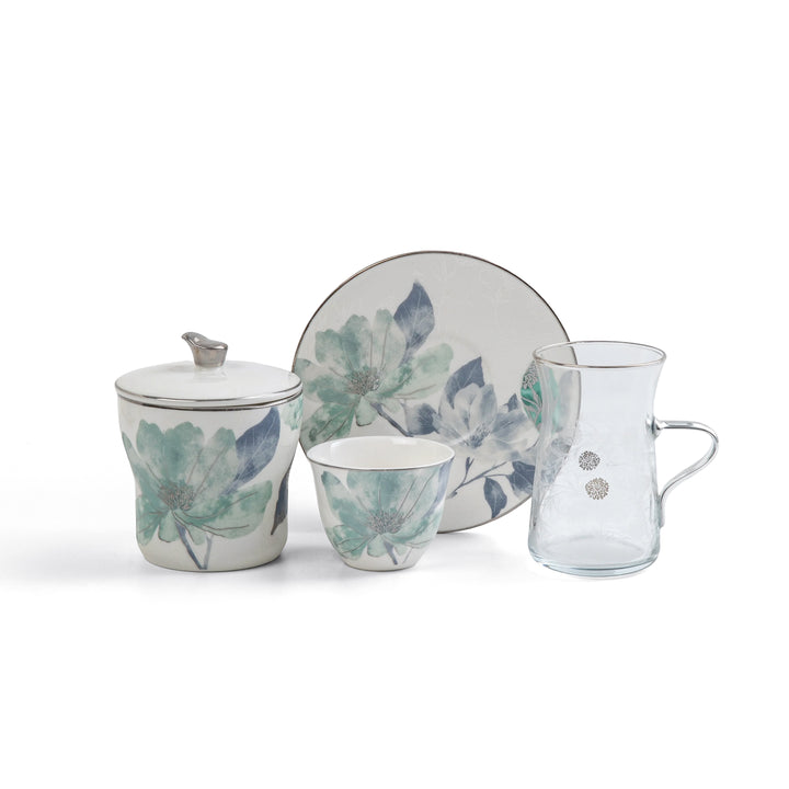 Ceramic tea set with floral design on a white background