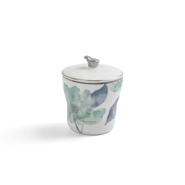 Decorative ceramic jar with floral design on a white background