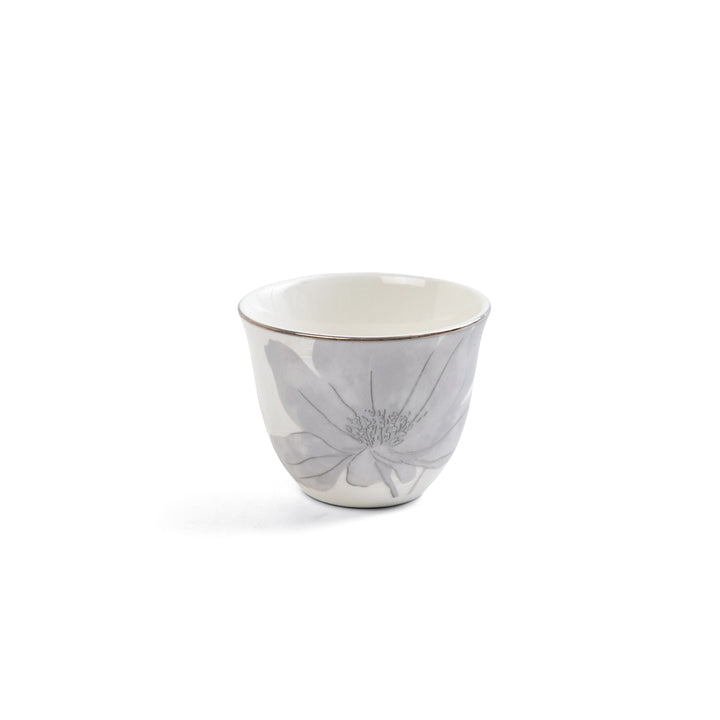 Ceramic cup with floral design on a white background