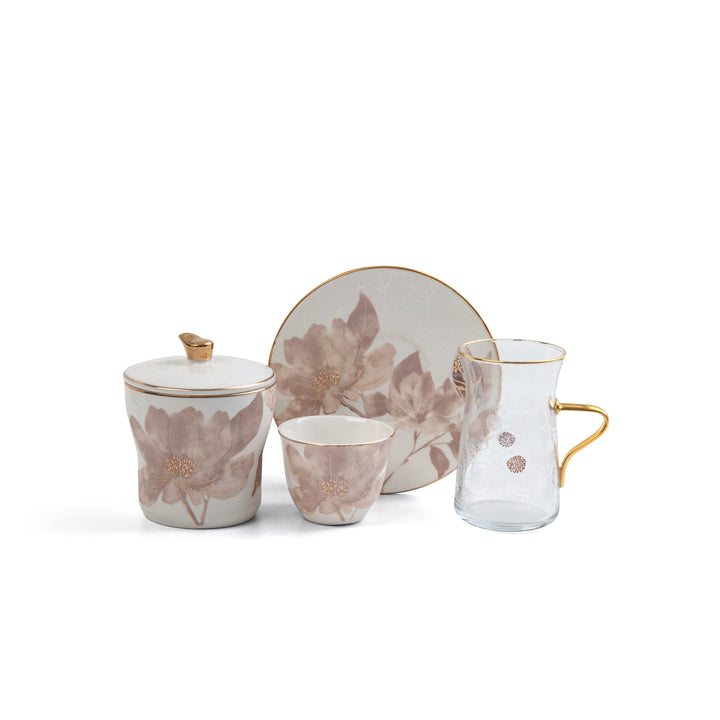 Set of ceramic tea accessories with floral design on a white background