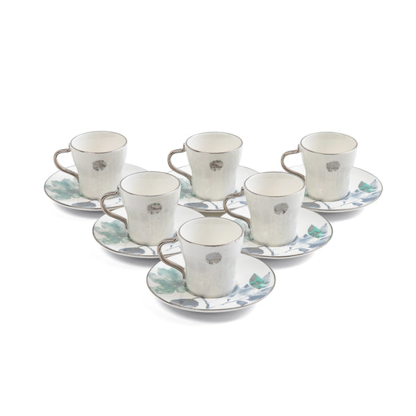 Set of six ceramic cups and saucers with floral patterns on a white background