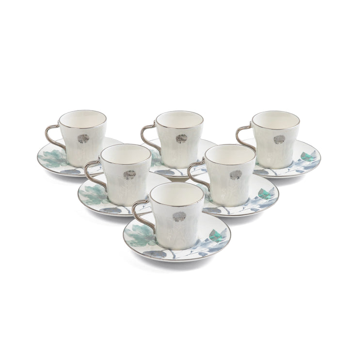 Set of six ceramic cups and saucers with floral patterns on a white background