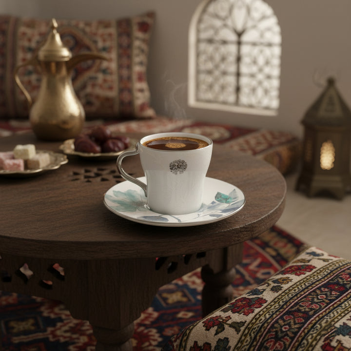 Steaming coffee cup on a saucer with a decorative background