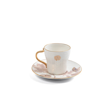 Ceramic cup and saucer set with floral design on a white background