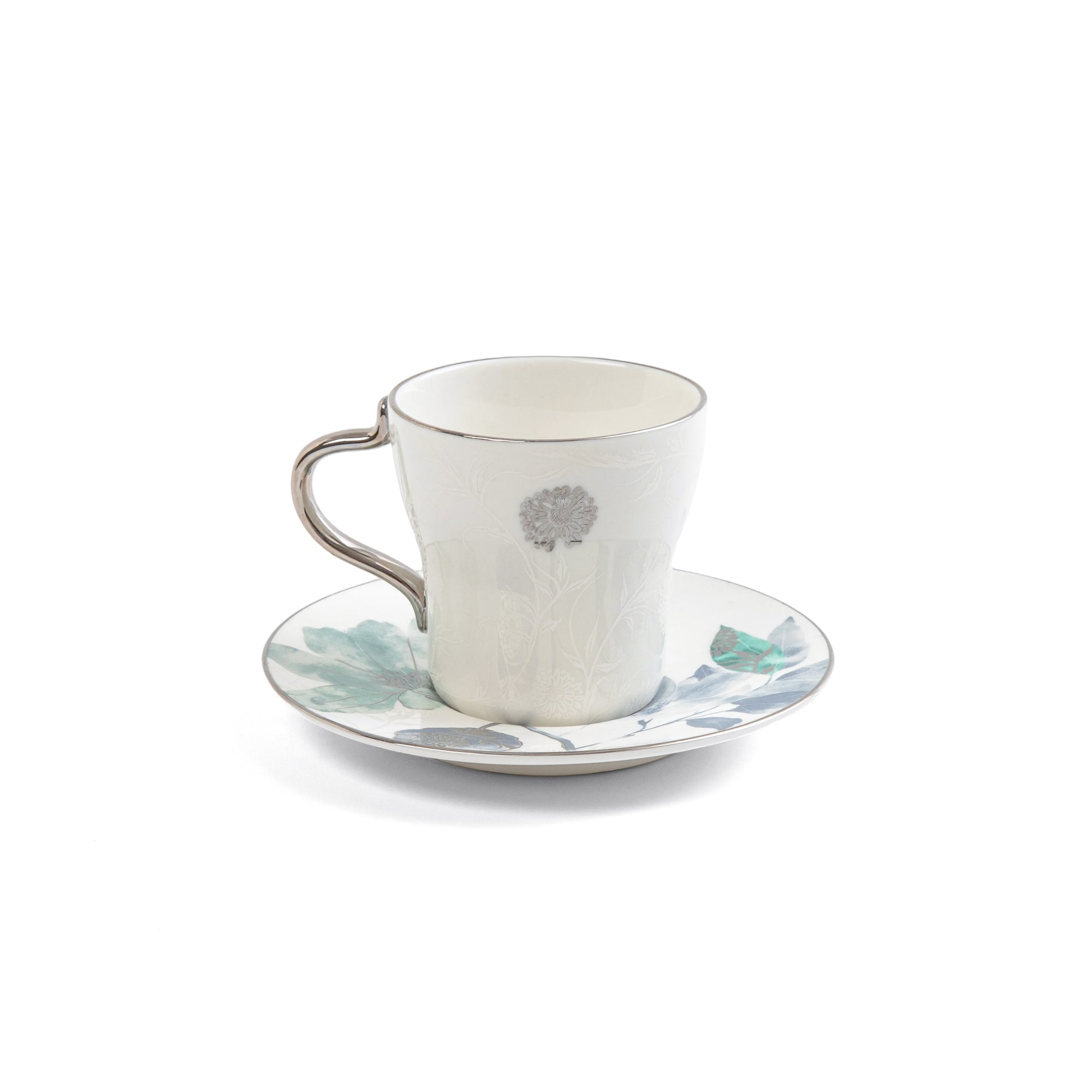Ceramic cup and saucer with floral design on a white background