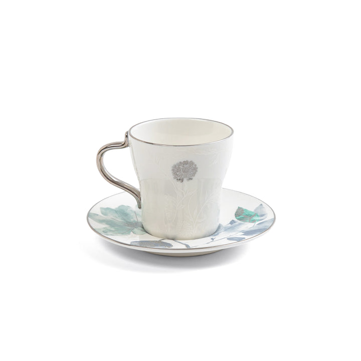 Ceramic cup and saucer with floral design on a white background