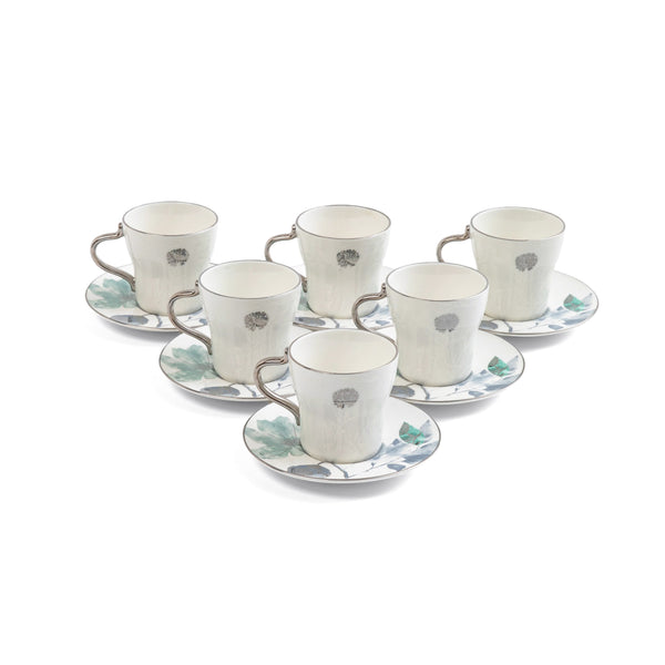 Set of six ceramic cups and saucers with floral patterns on a white background