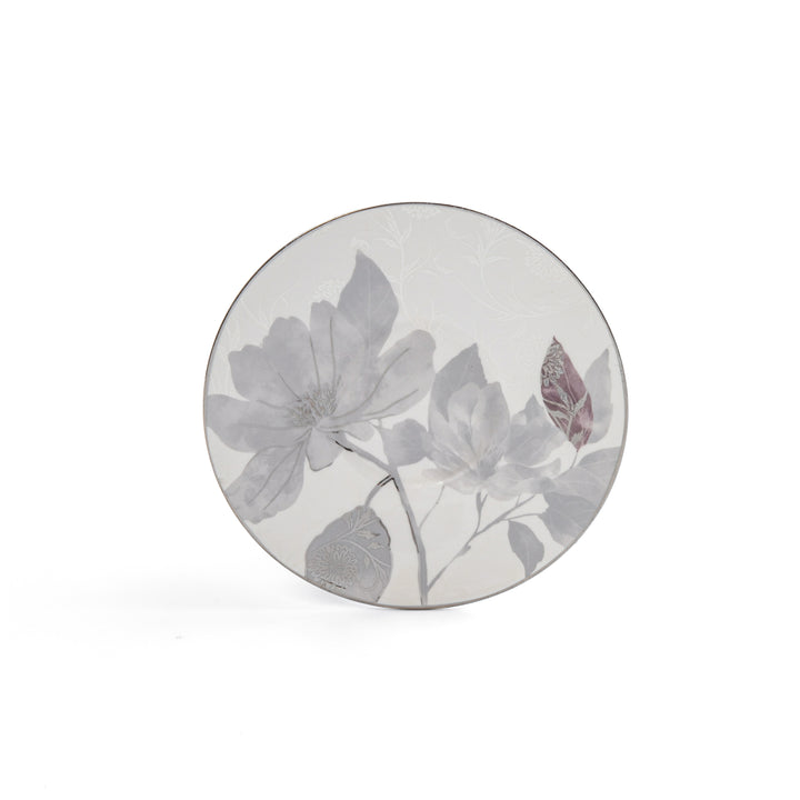 Round ceramic plate with floral design on a white background
