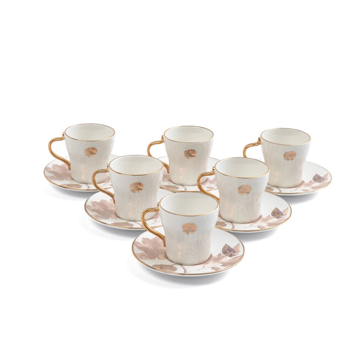 Set of six ceramic tea cups and saucers with gold accents on a white background