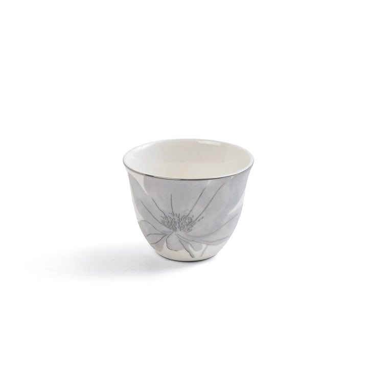 Ceramic cup with floral design on a white background