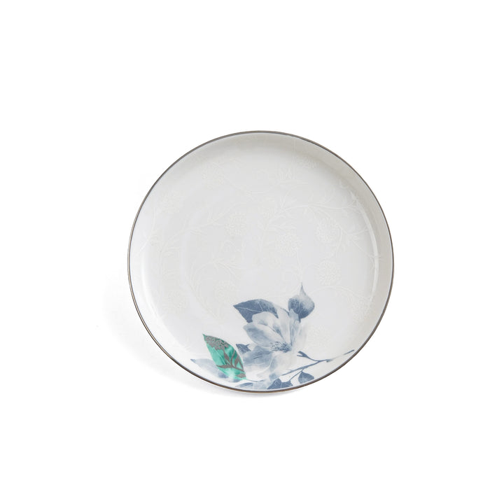 White ceramic plate with floral design on a white background